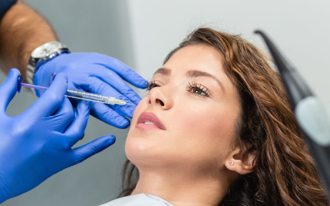 Attractive young woman is getting a rejuvenating facial injections