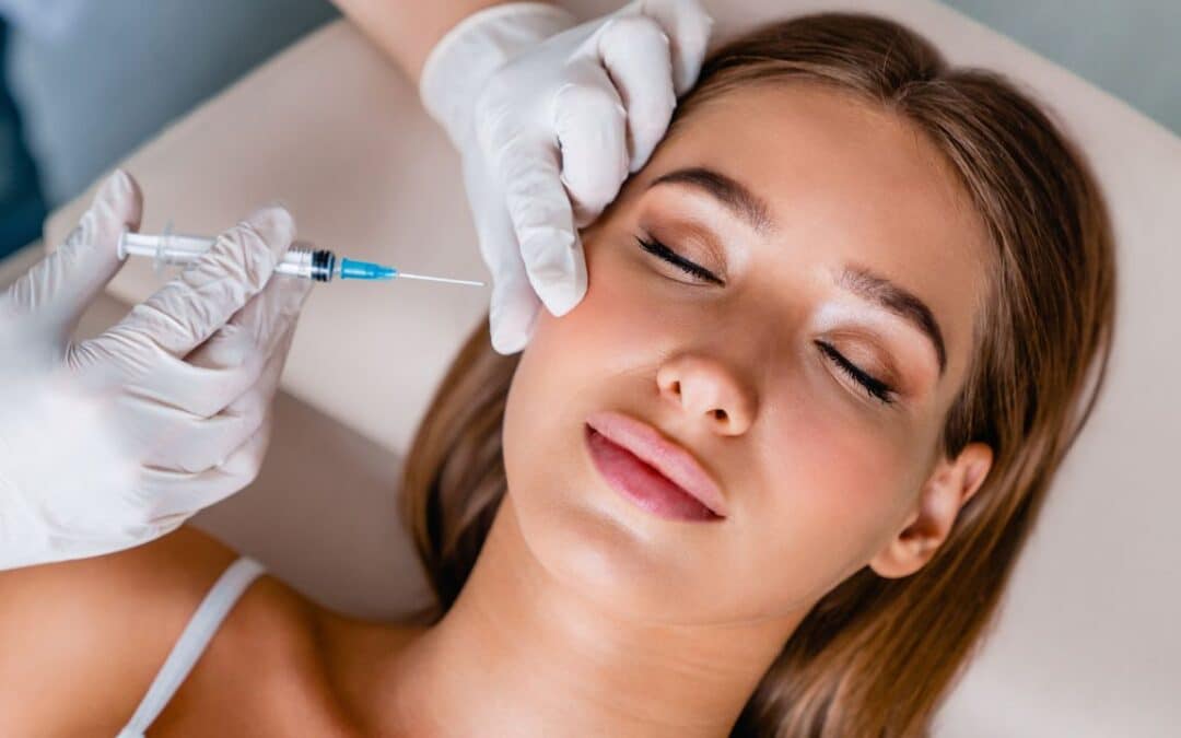Young woman gets beauty facial injections in salon